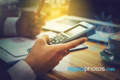 Business Man Sitting On A Calculator To Figure Out In A Coffee S… Stock Photo