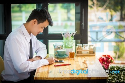 Business Man Using Mobile Phone While Sitting In The Coffee Shop… Stock Photo