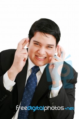 Business Man With Fingers Crossed Stock Photo