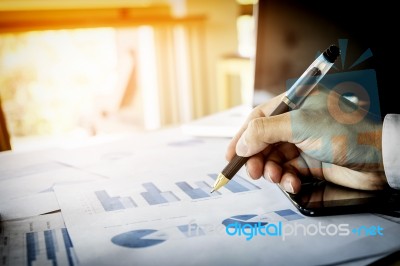 Business Man Working At Office With Laptop, Tablet And Graph Dat… Stock Photo