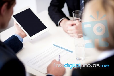 Business Partners Discussing Documents Stock Photo