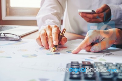 Business Team Two Colleagues Discussing New Plan Financial Graph… Stock Photo