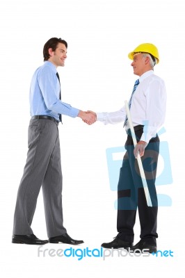Businessman And Architect Shaking Hands Stock Photo
