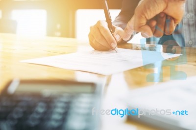 Businessman And Estate Agent Signing A Document For House Deal, Stock Photo