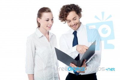Businessman And Woman Looking At Folder Stock Photo