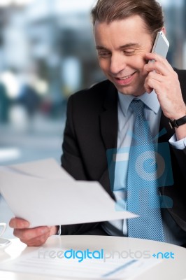 Businessman Communicatng On Phone Stock Photo
