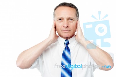 Businessman Covering His Ears With His Hands Stock Photo