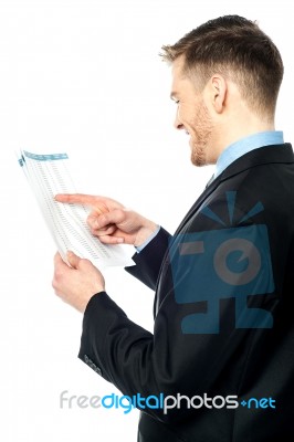 Businessman Cross-checking Annual Reports Stock Photo
