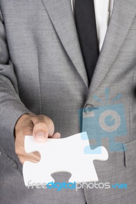 Businessman Holding Blank Jigsaw Stock Photo