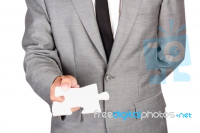 Businessman Holding Blank Jigsaw Stock Photo