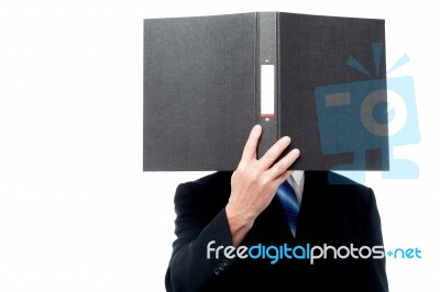 Businessman Holding File Pad And Cover His Face Stock Photo