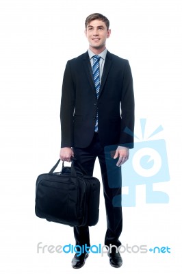Businessman In Black Suit Posing With Bag Stock Photo