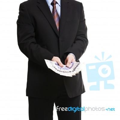 Businessman In Dark Suit With A Bunch Of British Pounds Sterling… Stock Photo