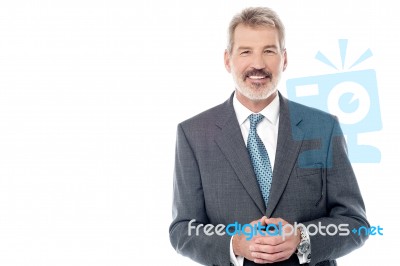 Businessman In Suit With Hands Clasped Stock Photo