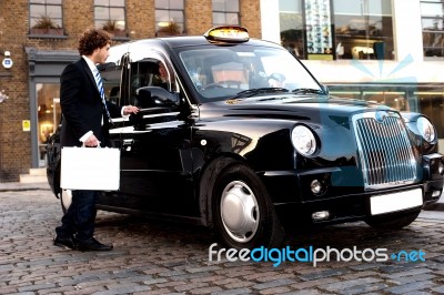 Businessman Interacting With Taxi Driver Stock Photo