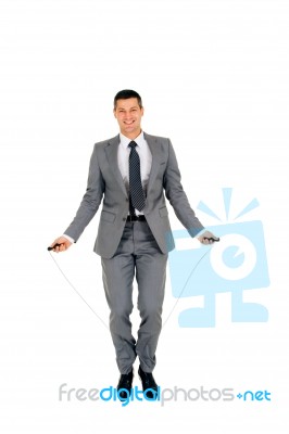 Businessman Jumping Rope Stock Photo