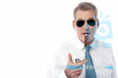 Businessman Lighting A Cigar Stock Photo
