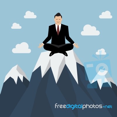 Businessman Meditating On A Mountain Peak Stock Image