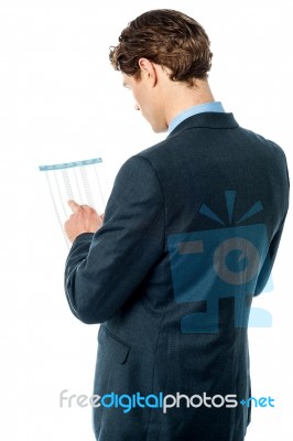 Businessman Reviewing Business Report Stock Photo