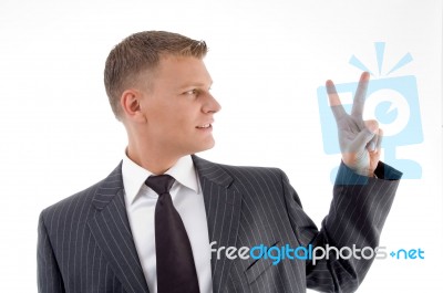 Businessman Showing Peace Sign Stock Photo