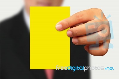 Businessman Showing Yellow Paper Stock Photo