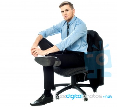 Businessman Sitting On Revolving Chair Stock Photo