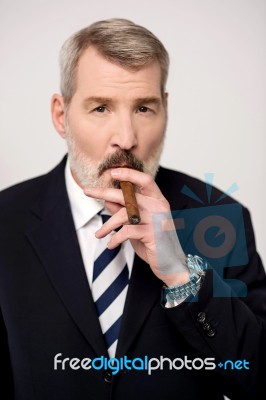 Businessman Smoking Cigar Stock Photo