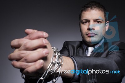 Businessman Struggles Against Chains Stock Photo