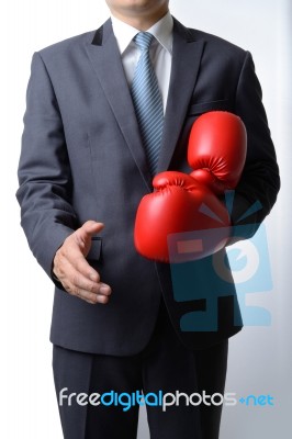 Businessman Take Off Boxing Gloves To Offer A Handshake On White… Stock Photo
