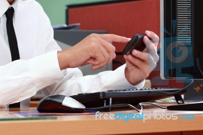 Businessman Using Smart Phone During Working Stock Photo
