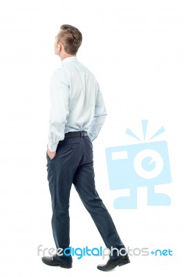 Businessman Walking Forward, Hands In Pocket Stock Photo