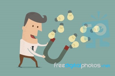 Businessman With Horseshoe Magnet Collecting Light Bulb Stock Image
