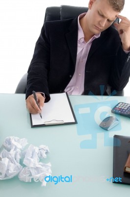 Businessman Writing On Clipboard Stock Photo