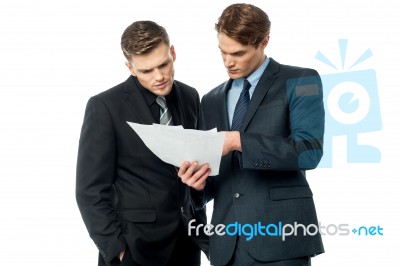 Businessmen Evaluating Deal Documents Stock Photo