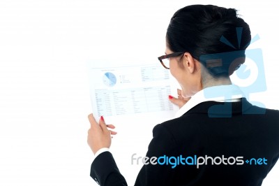 Businesswoman Reviewing Annual Report Stock Photo