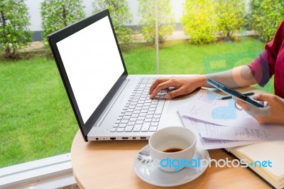 Businesswoman Typing On Laptop With Blank White Screen For Mock Stock Photo