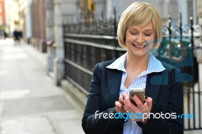 Businesswoman Using Her Smart Phone Stock Photo