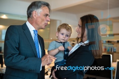 Businesswoman With Small Child In The Office Stock Photo