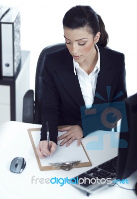 Busy Business Lady Making Her Notes On The Clipboard Stock Photo