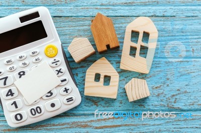 Calculator And Wood House With Blank Card Stock Photo