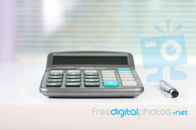 Calculator On A White Table Stock Photo