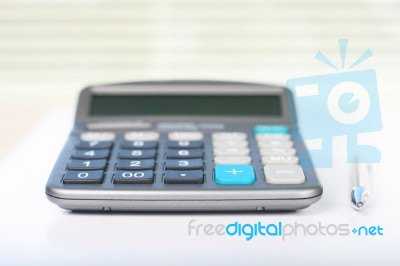 Calculator On A White Table Stock Photo