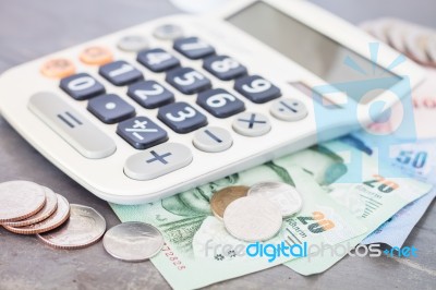 Calculator With Money On Grey Background Stock Photo