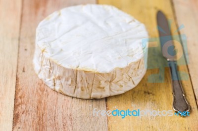 Camembert Cheese And Vintage Knife On Wooden Table Stock Photo
