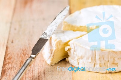 Camembert Cheese With Cut Wedge And Vintage Knife On Wooden Tabl… Stock Photo