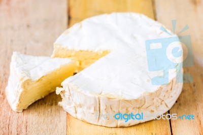 Camembert Cheese With Cut Wedge And Vintage Knife On Wooden Tabl… Stock Photo