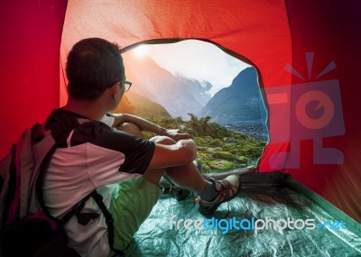 Camping Man In Camper Tent Looking To Beautiful Natural Water Falls Scenic Use For People Vacation Traveling To Destination Stock Photo