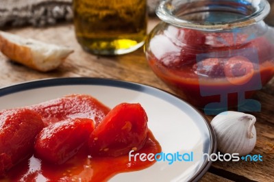 Canned Tomatoes In A Glass Jar Stock Photo