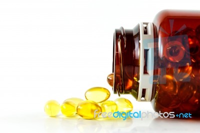 Capsules Of Fish Oil Spilled From Bottle Horizontal Stock Photo
