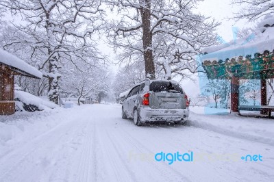 Car And Falling Snow In Winter On Forest Road With Much Snow Stock Photo